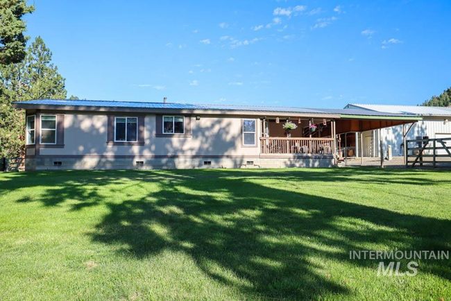 Rear view of house with crawl space and a metal roof | Image 36