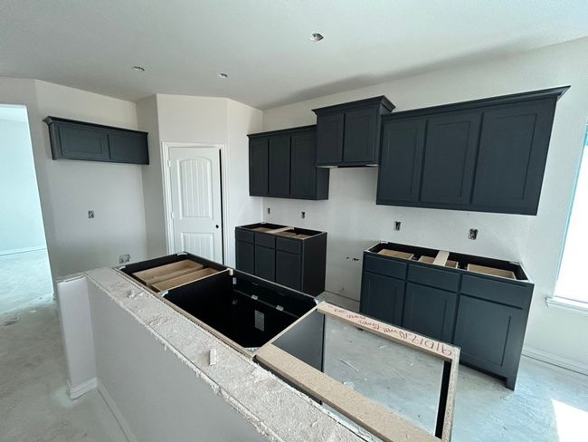Kitchen featuring baseboards and concrete flooring | Image 7