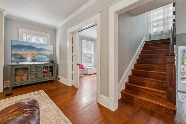 Stairway with hardwood / wood-style flooring and ornamental molding | Image 20