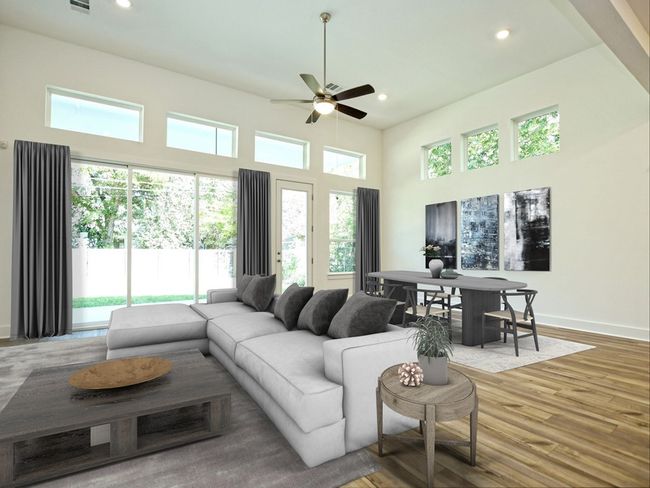 Living area featuring a ceiling fan, recessed lighting, wood finished floors, and a high ceiling | Image 5