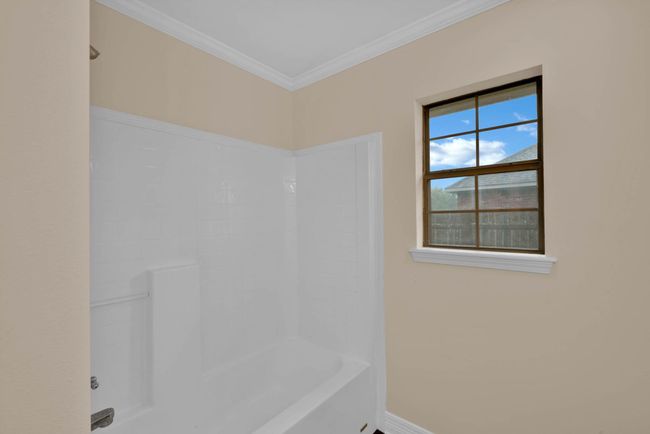 Bathroom featuring shower / bath combination and ornamental molding | Image 27