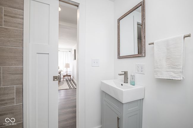 bathroom with baseboards, wood finished floors, and vanity | Image 23