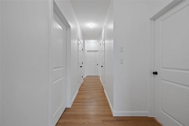 Corridor featuring light wood-type flooring and baseboards | Image 32