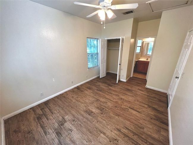 Unfurnished bedroom featuring dark wood-style floors, a closet, and ceiling fan | Image 11