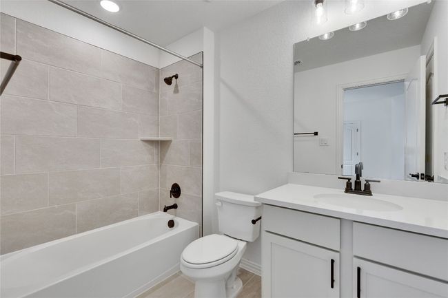 Full bath with vanity, shower / washtub combination, and tile patterned floors | Image 18
