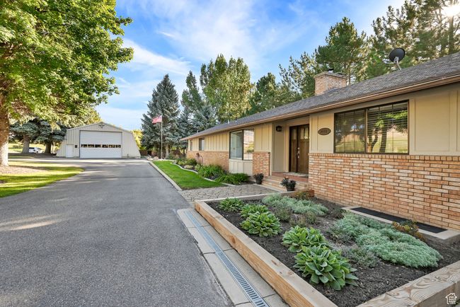 Ranch-style home featuring a garage and an outbuilding | Image 4