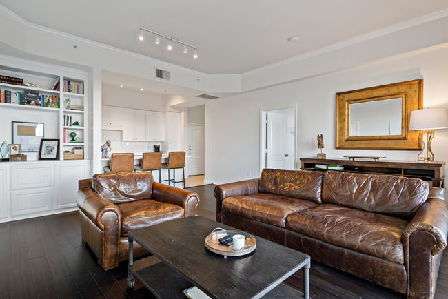 Living room featuring track lighting, ornamental molding, dark wood finished floors, and visible vents | Image 4
