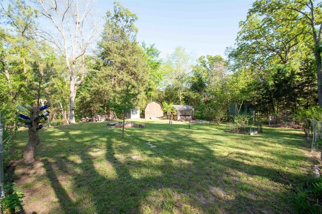 Distant View of yard with a shed, a garden, an outdoor structure, and fenced area for your pets. | Image 11