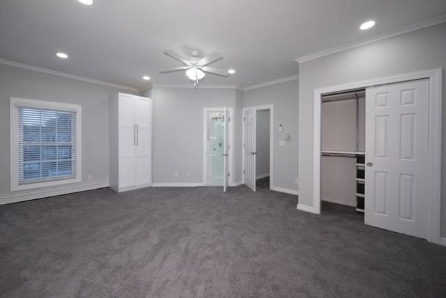 Unfurnished bedroom with recessed lighting, ornamental molding, dark colored carpet, and ceiling fan | Image 8