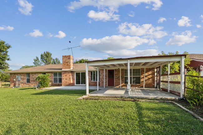 Back of property with a chimney, a patio, and brick siding | Image 26