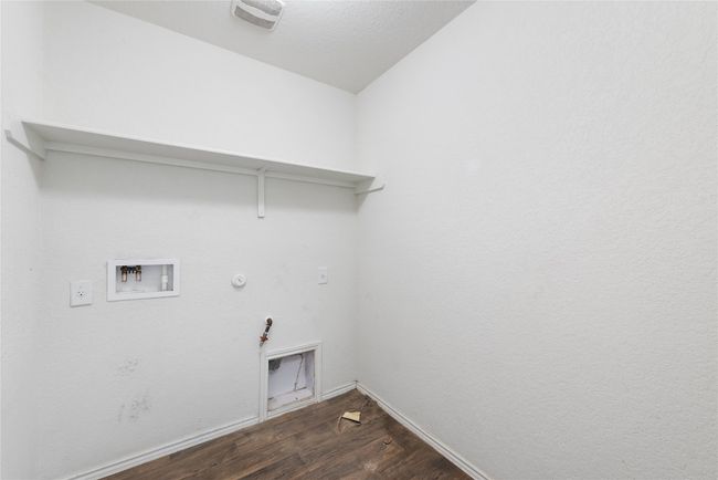 Laundry room featuring hookup for a gas dryer, dark wood-type flooring, and hookup for a washing machine | Image 19