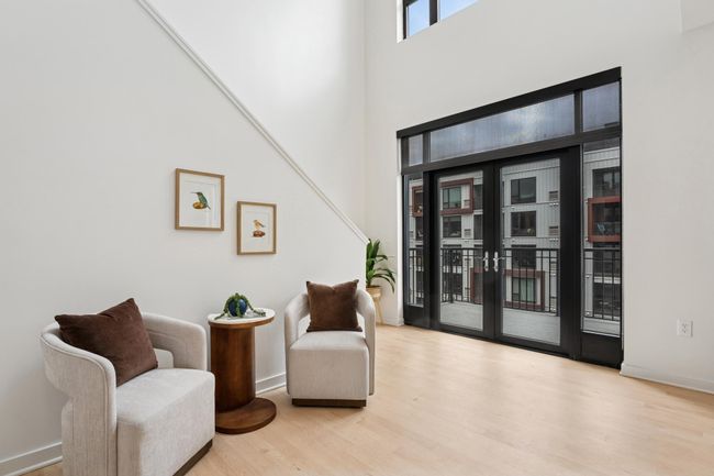 Step out to your private balcony from this serene seating space—an ideal blend of indoor comfort and outdoor living. | Image 14