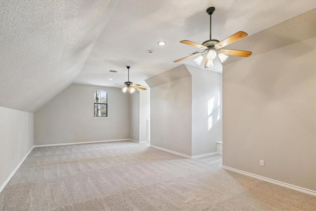 On the second level, a large game room features charming dormer windows accented with storage benches. This room could be divided to make additional bedrooms or utilized for a variety of purposes such as a play room, fitness studio or craft room. | Image 33