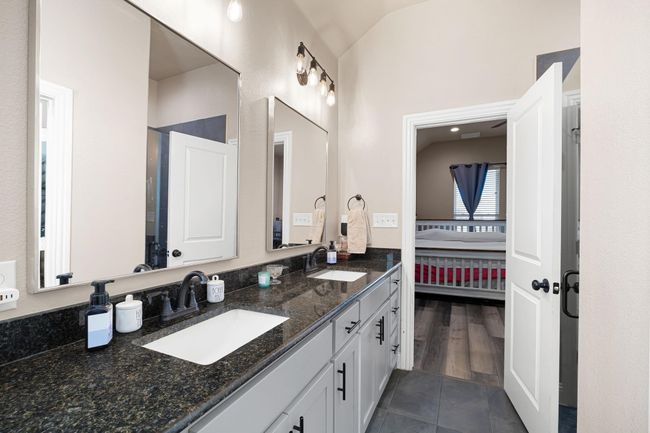 Ensuite bathroom with double vanity, a sink, vaulted ceiling, and ensuite bathroom | Image 26