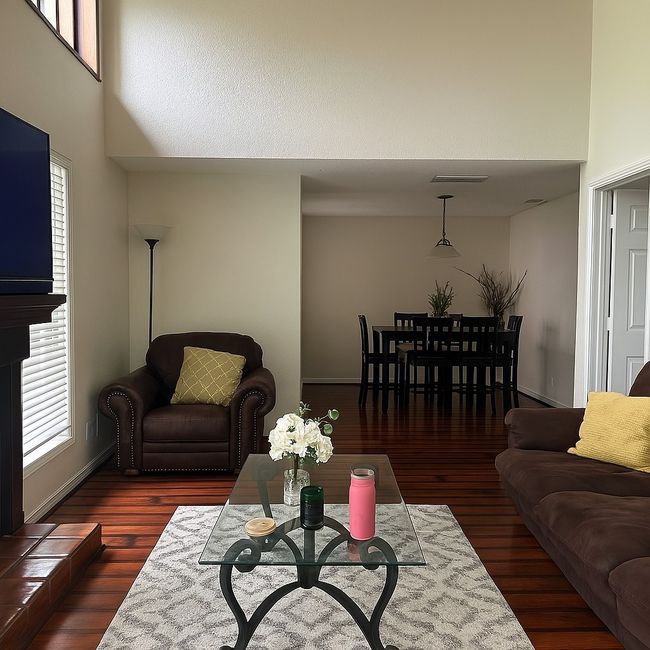 Living area with wood finished floors and a high ceiling | Image 4