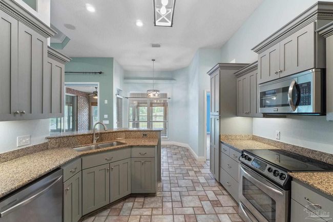 7008 Turnberry Cir, House other with 4 bedrooms, 2 bathrooms and 3 parking in Navarre FL | Image 28