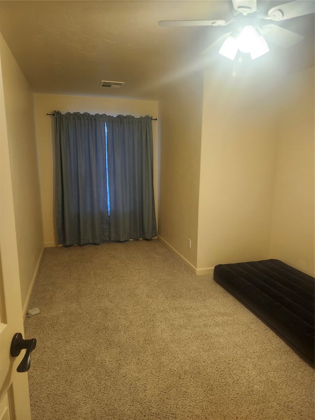 Spare room featuring visible vents, a ceiling fan, carpet flooring, and baseboards | Image 10