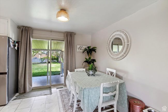 Dining space featuring light marble finish floors | Image 7