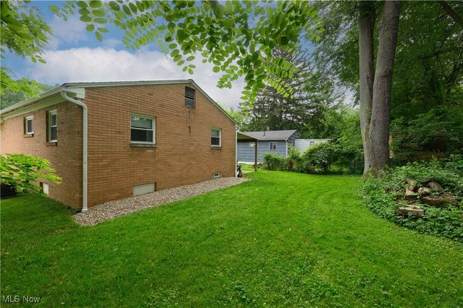View of side of property with a lawn and brick siding | Image 20