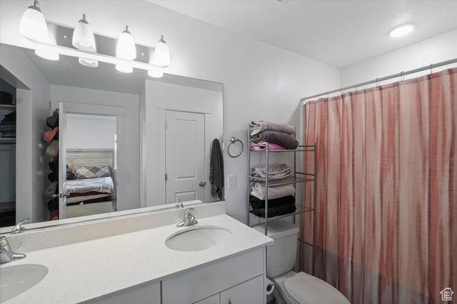 Master bathroom featuring toilet, double vanity, a sink, and connected bathroom | Image 13