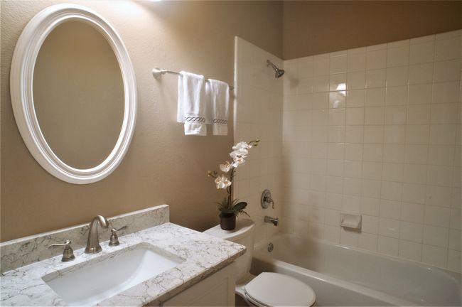 Bathroom featuring vanity, bathtub / shower combination, and toilet | Image 15