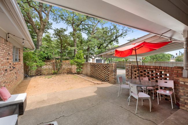 Fenced backyard with outdoor dining space and a patio | Image 19