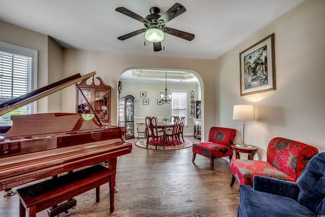 featuring arched walkways, a ceiling fan, and lvp flooring | Image 6