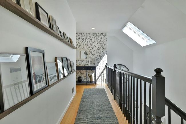 Upstairs, the gallery is flooded with light from the skylights. | Image 16