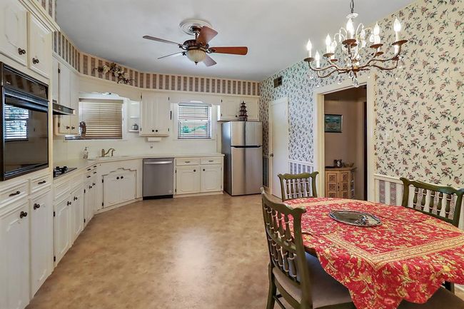 Another view of the kitchen with breakfast table. | Image 15