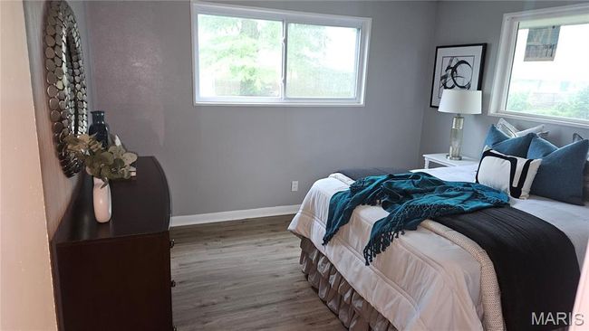 Bedroom featuring multiple windows and wood finished floors | Image 9