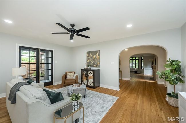 Living room featuring arched walkways, a ceiling fan, recessed lighting, and wood finished floors | Image 9