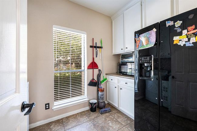 Laundry room with room for a second fridge and additional storage. | Image 20