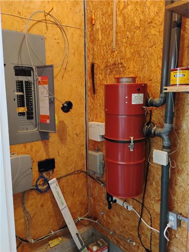 Garage utilities featuring electric panel & central vacuum | Image 79