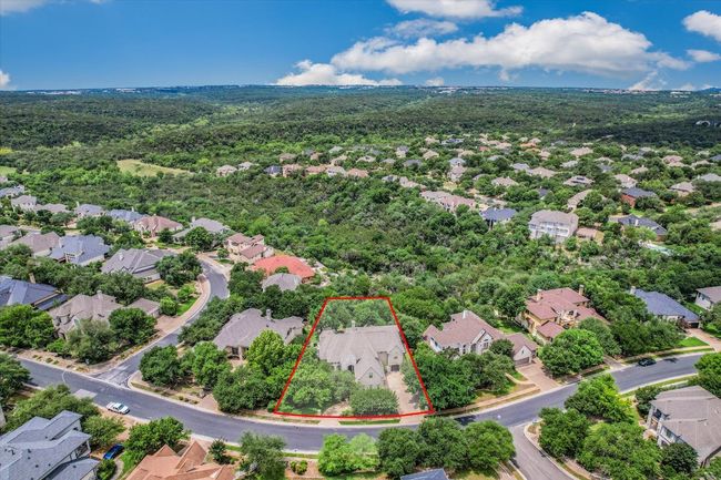 Aerial view of the neighborhood with property parcel outlined and a forest of trees in the canyon below. | Image 40
