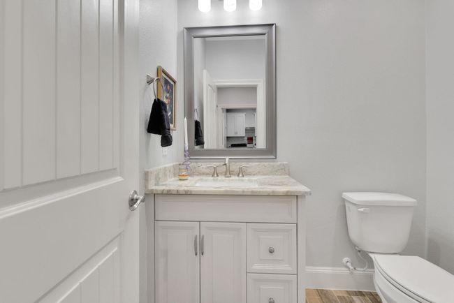 A conveniently located half bath sits just off the oversized garage—perfect for guests or quick clean-ups after a busy day. | Image 34