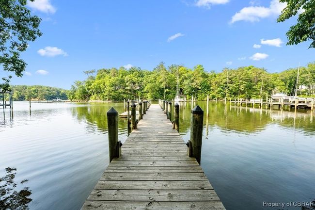 Dock featuring a water view and a forest view | Image 12