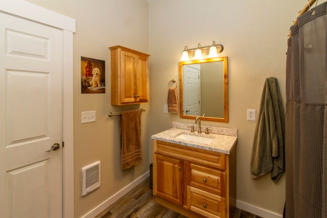 Full bath with heating unit, vanity, and baseboards | Image 11