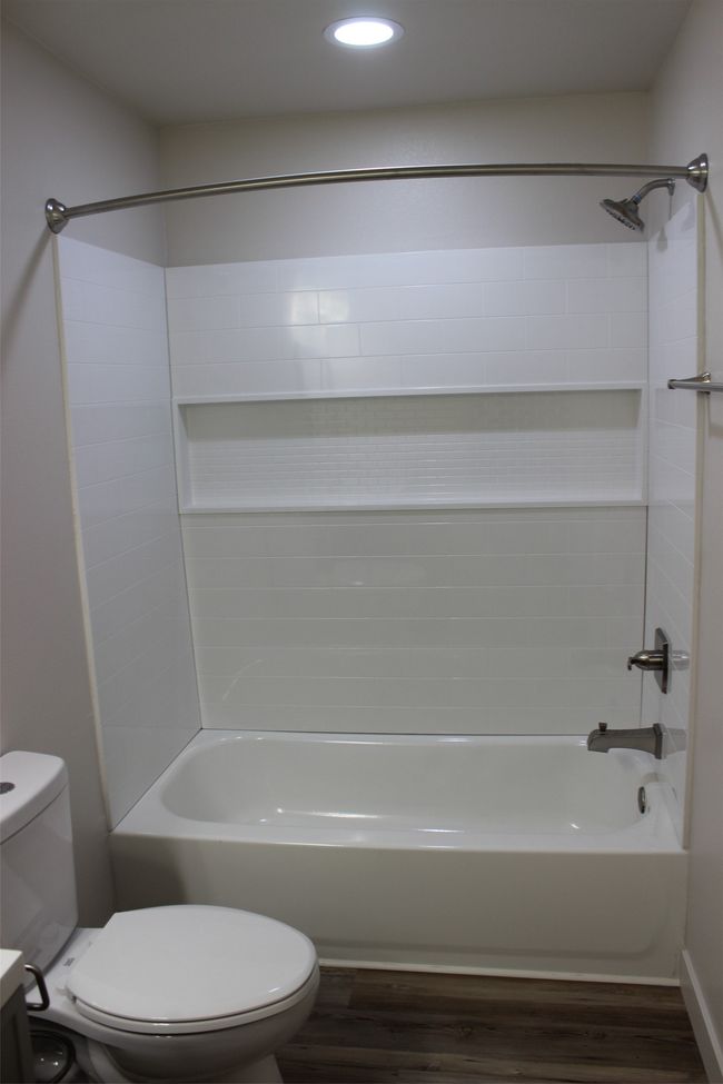 Full bathroom featuring wood finished floors, tub / shower combination, and recessed lighting | Image 15