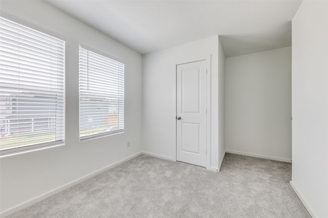 Unfurnished bedroom featuring light carpet and baseboards | Image 5