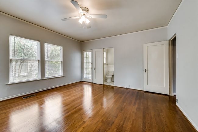 Unfurnished room with a ceiling fan, wood finished floors, and crown molding | Image 22