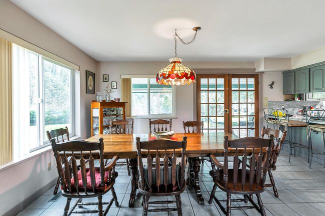 Dining room with baseboards, plenty of natural light, light tile patterned flooring, and french doors | Image 13