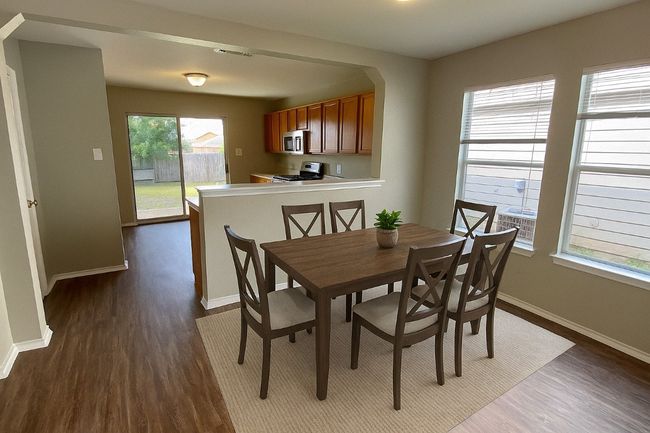 Dining space featuring dark wood-style floors and arched walkways | Image 10