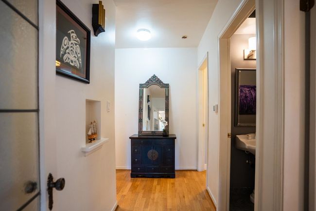 Hall with wood finished floors and baseboards | Image 5