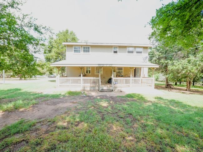 View of front facade with a porch and a front yard | Image 27