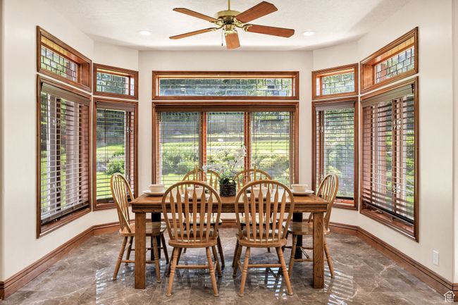 Dining area featuring marble tiled floors, healthy amount of natural light, a ceiling fan, and recessed lighting | Image 13