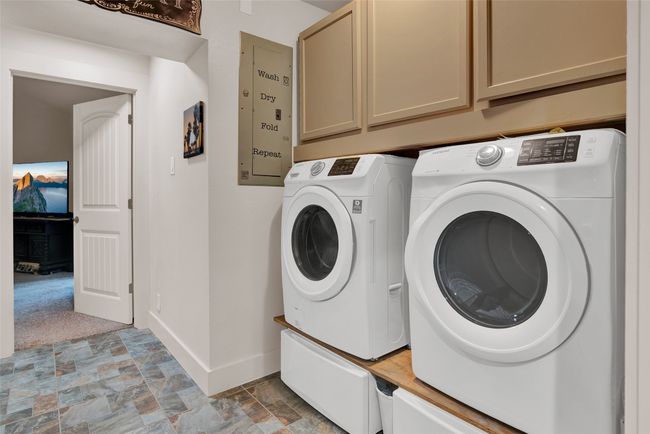 Down the hallway to the second primary bedroom, there is a nice large laundry area. | Image 28