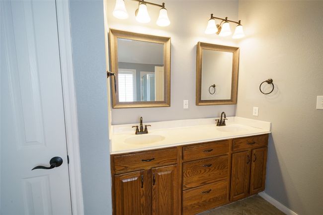 Bathroom with double vanity and tile patterned floors | Image 18