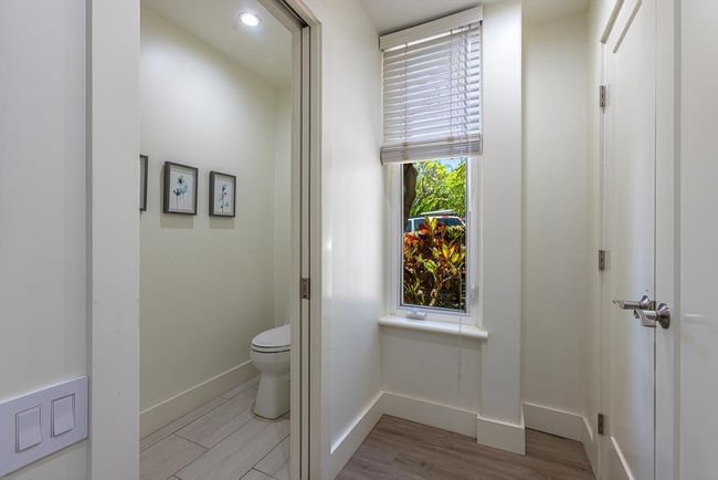 A tall window adds natural light to the primary bathroom area | Image 19