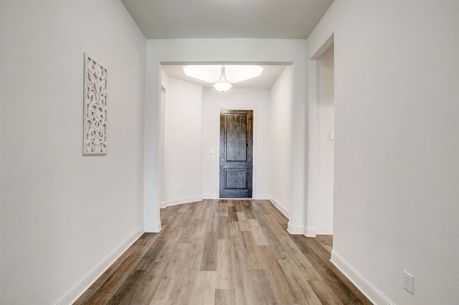 Hall featuring wood finished floors and baseboards | Image 5