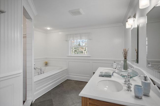 Full bathroom featuring tile patterned flooring, ornamental molding, a sink, a garden tub, and double vanity | Image 34